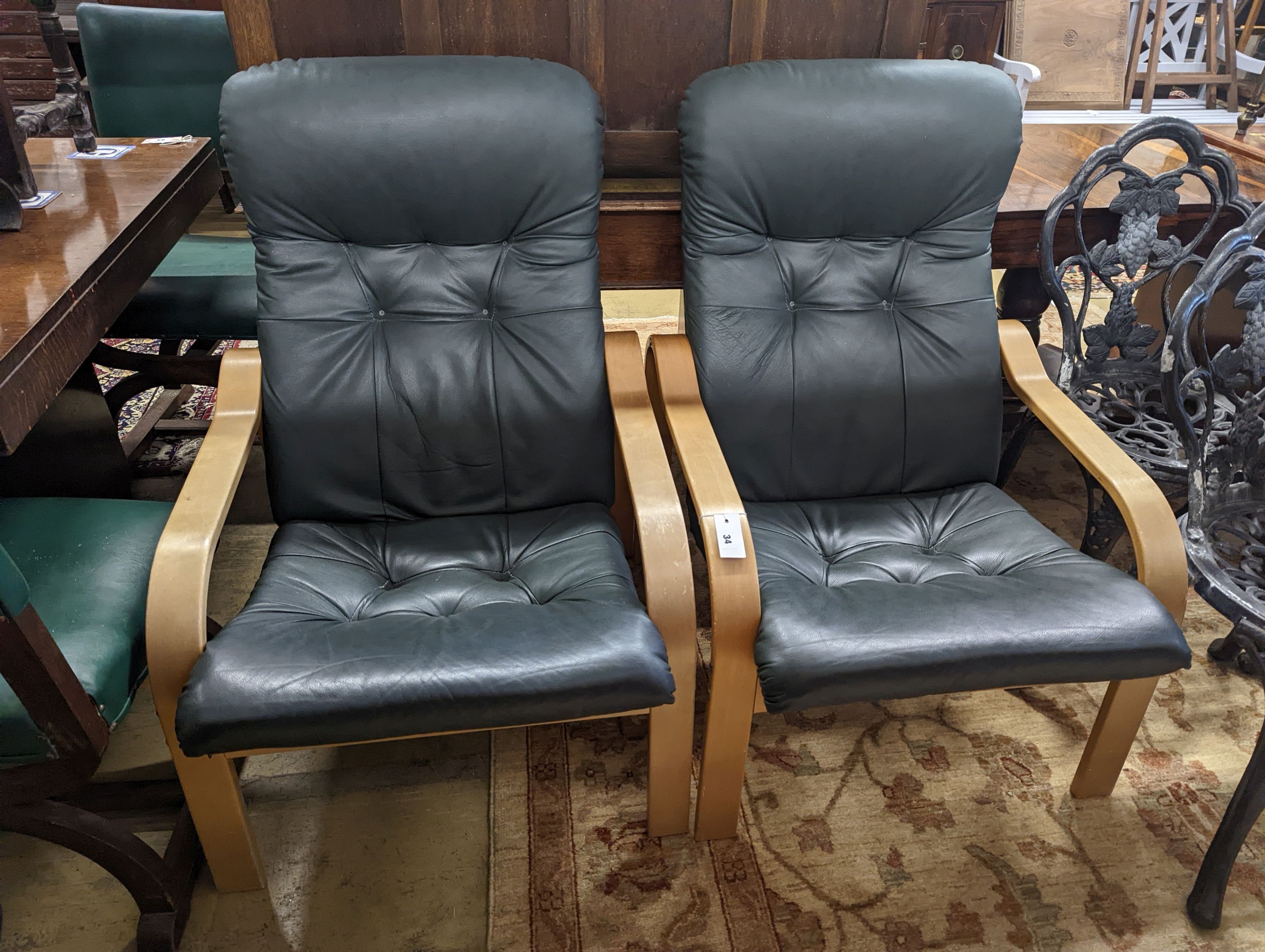 A pair of mid century Norwegian green leather and bent ply armchairs, width 68cm, depth 80cm, height 96cm